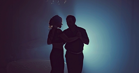 Couple dancing romantic tango at night. Silhouette couple ballroom. Smoke